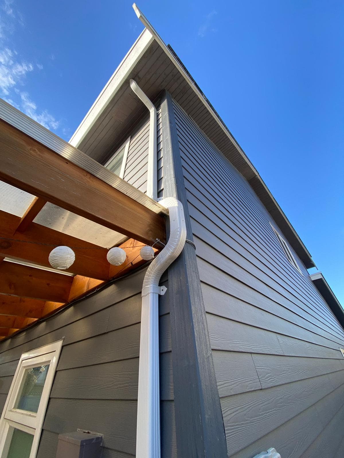 New downspout and siding installation