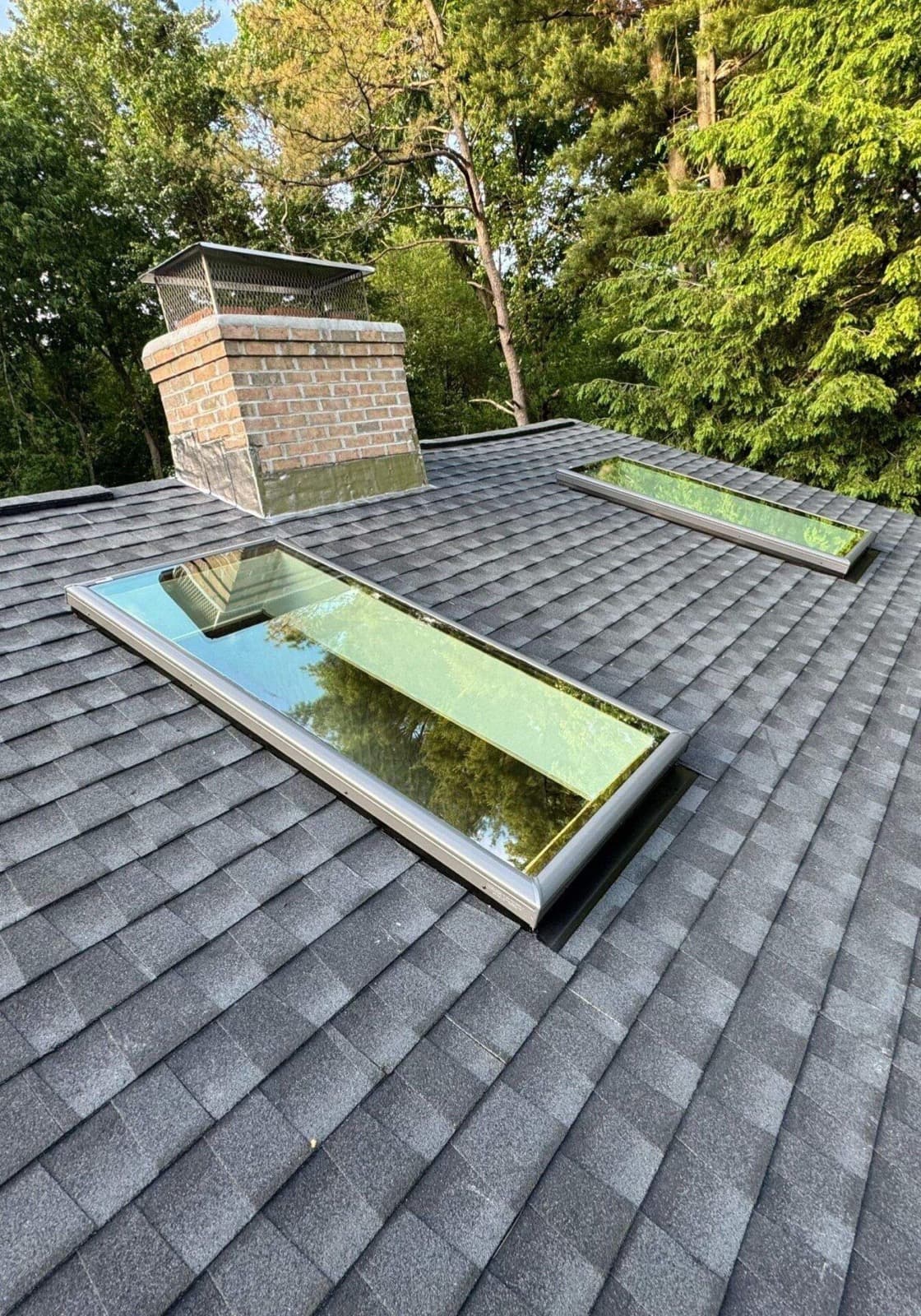 Completed Velux skylights on charcoal shingle roof