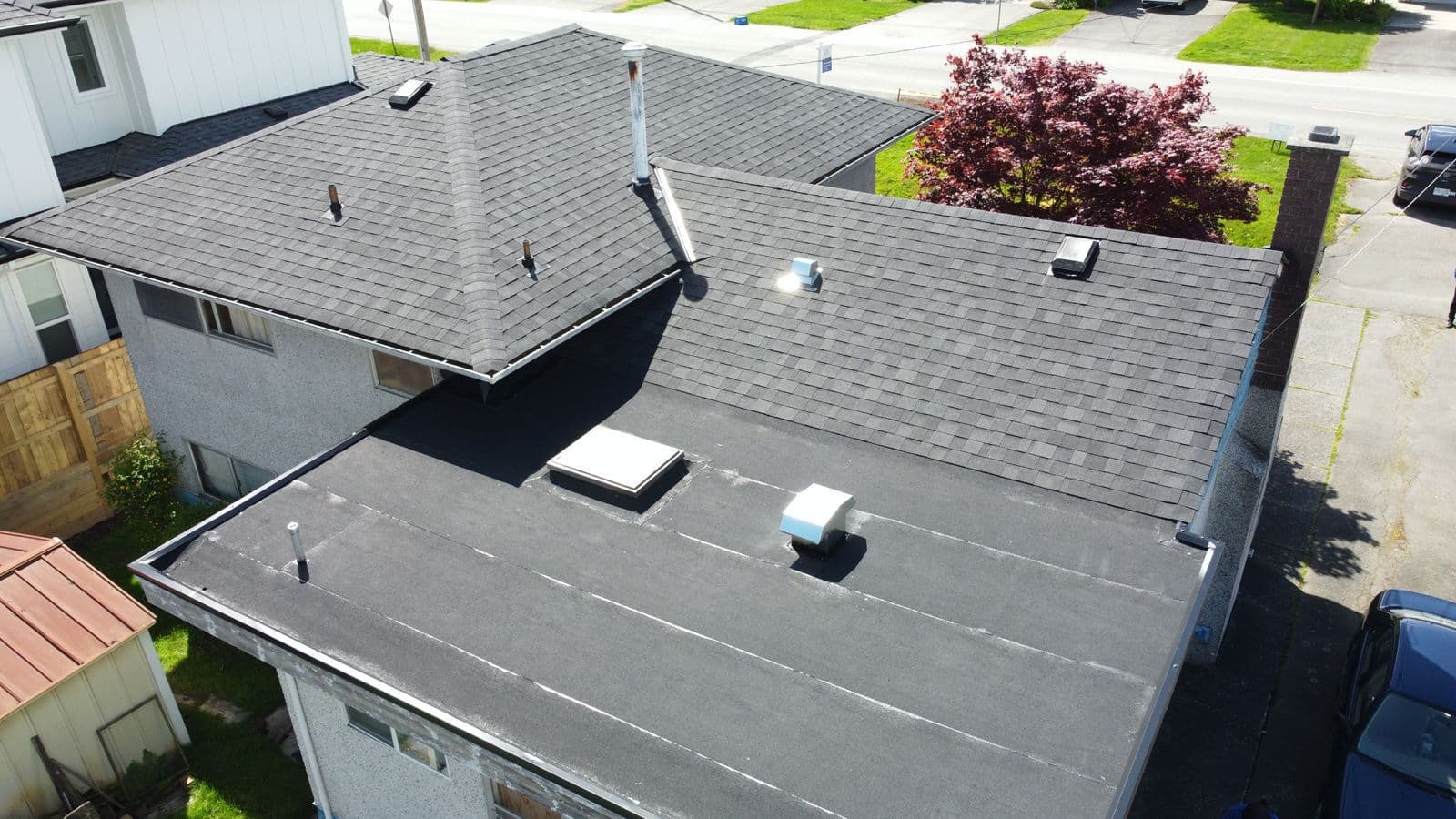 Aerial view of a completed asphalt shingle roof replacement in the Lower Mainland
